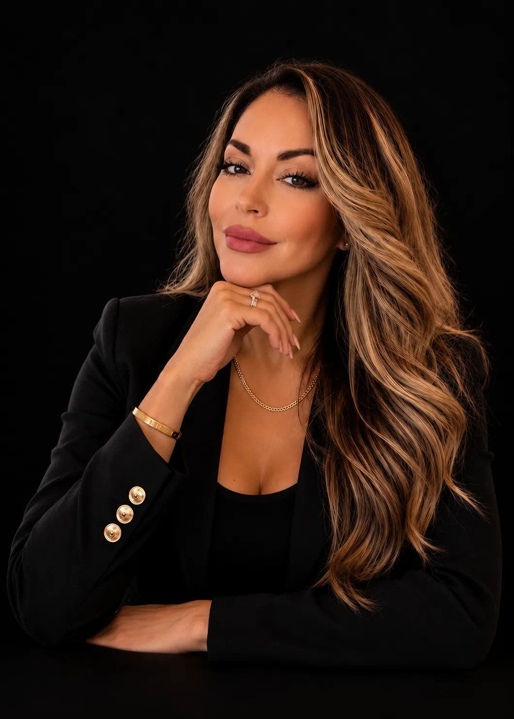 Vicky Valdovinos in a black blazer, photographed against a dark backdrop